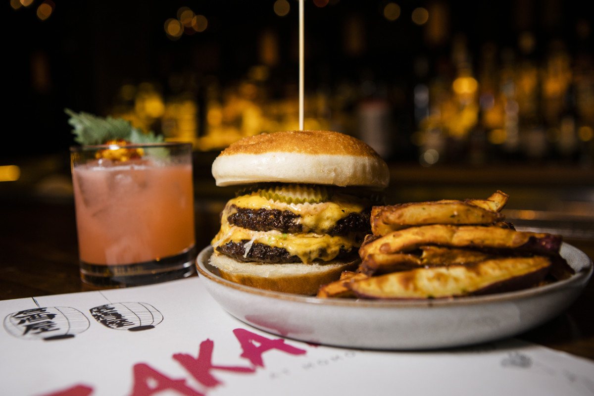 A burger and cocktail on a Chicago bar